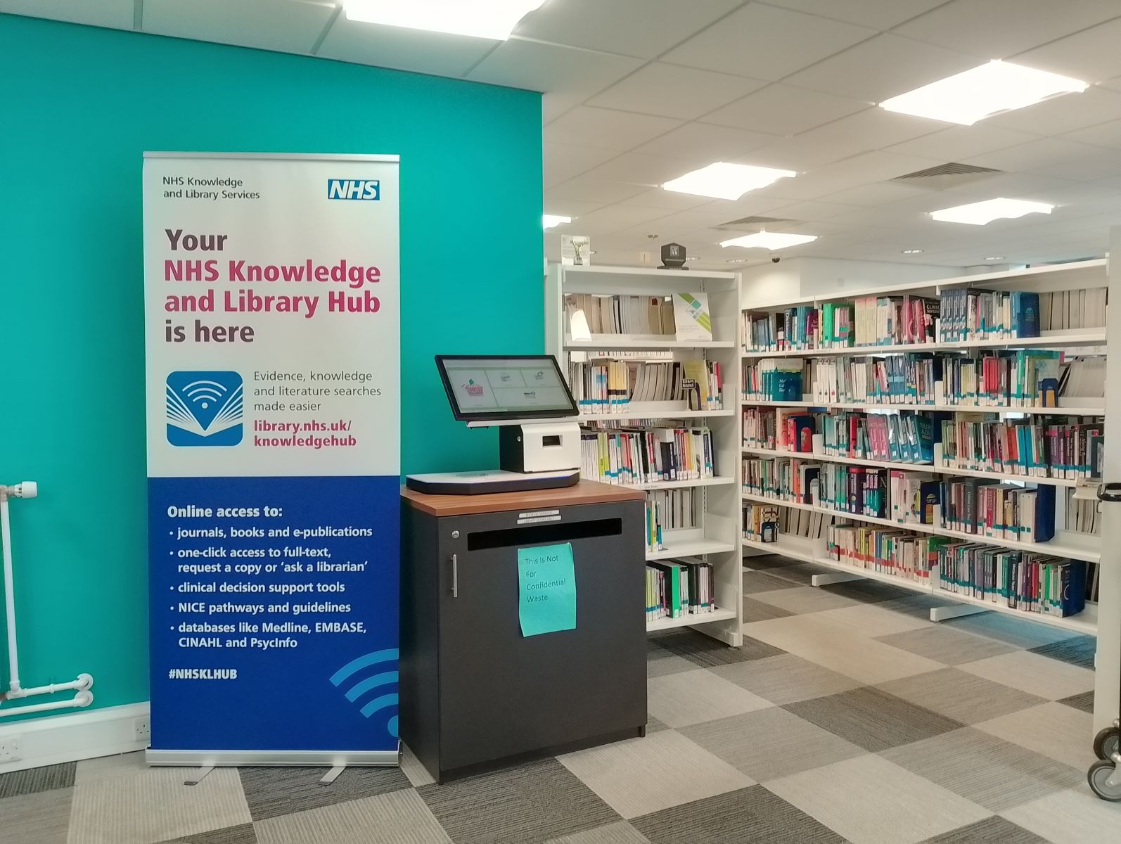 Photo of inside Wigan Library, shelves with books