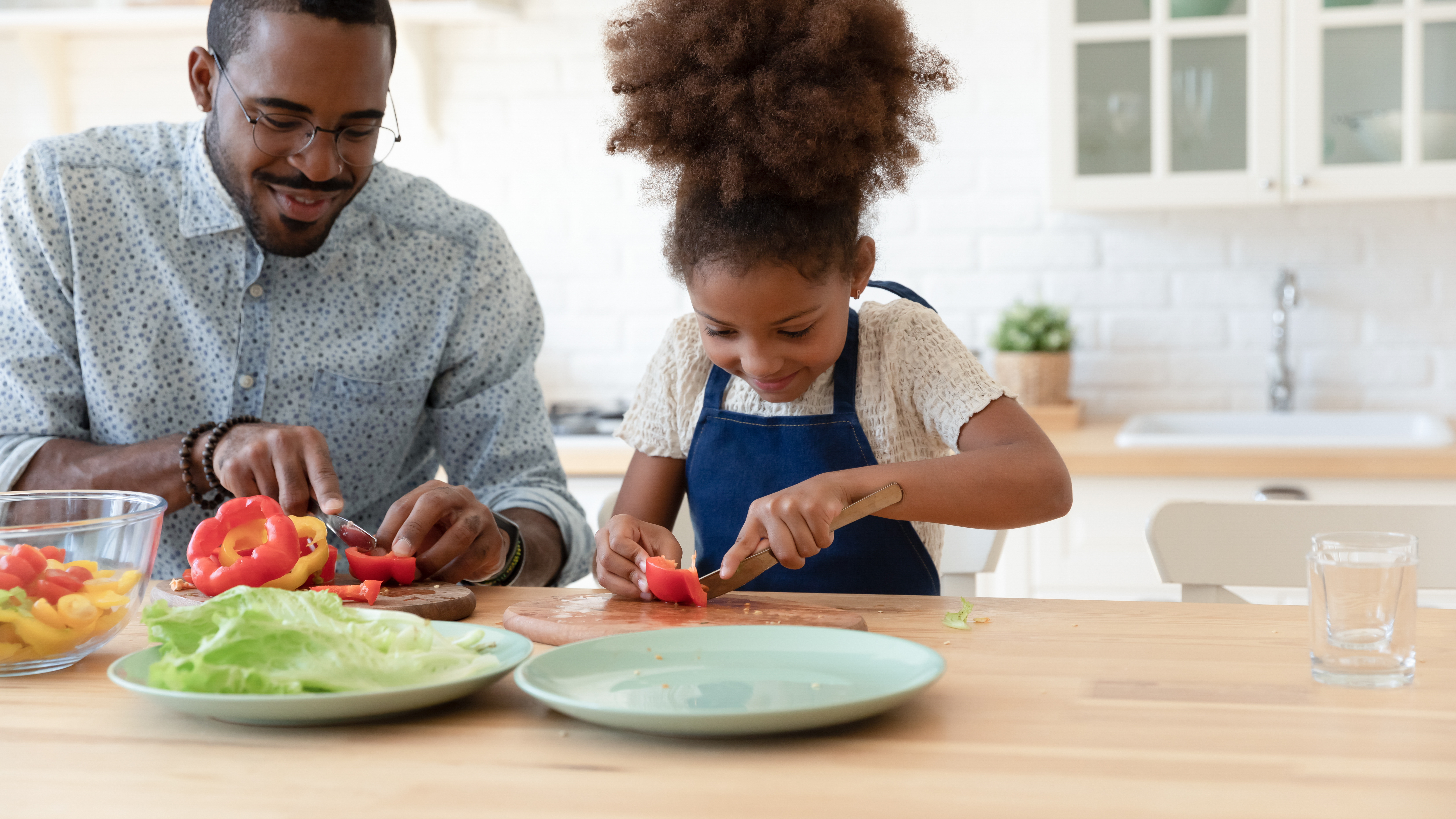 Photo of a parent and child cooking together