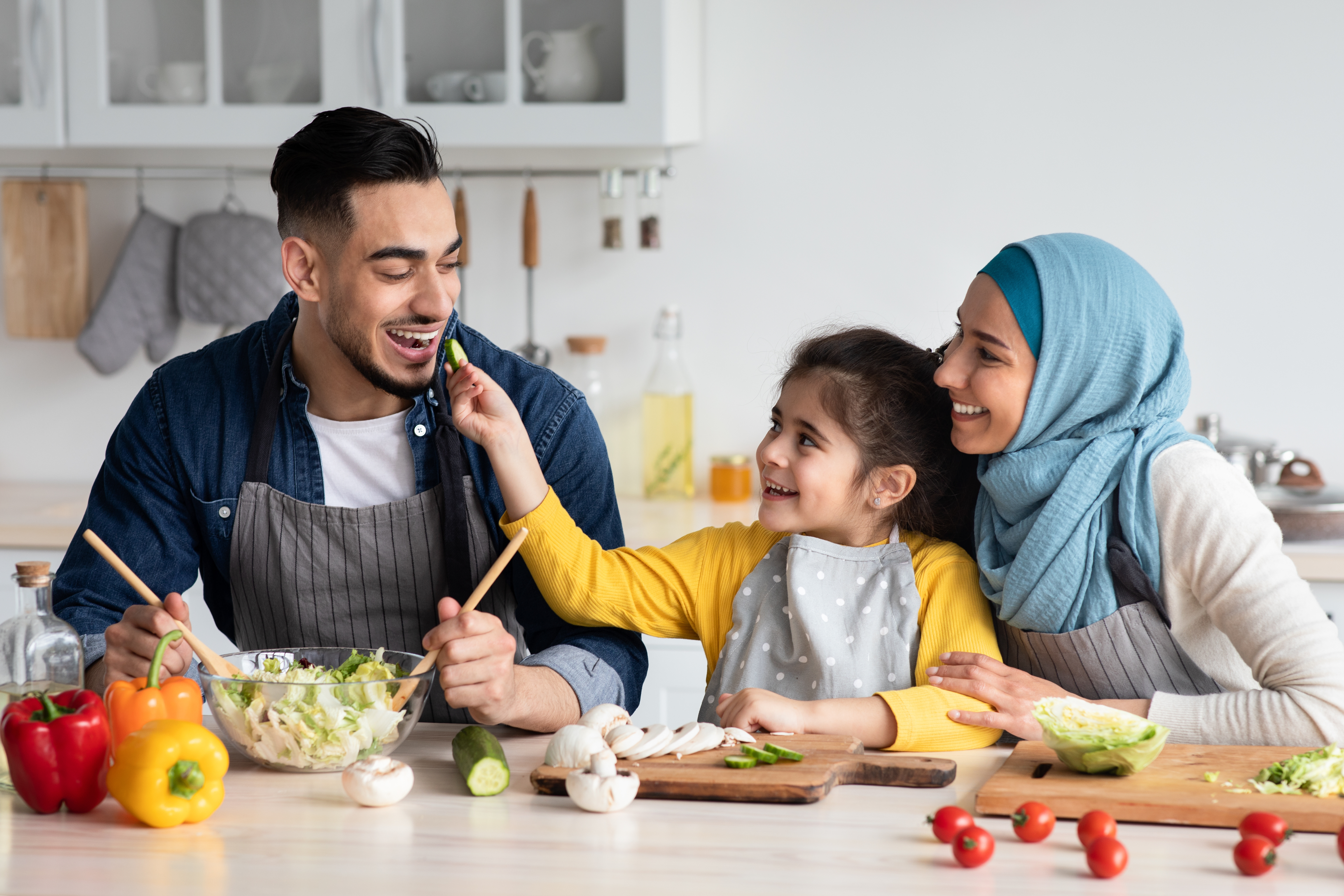 Photo of a family cooking and eating together