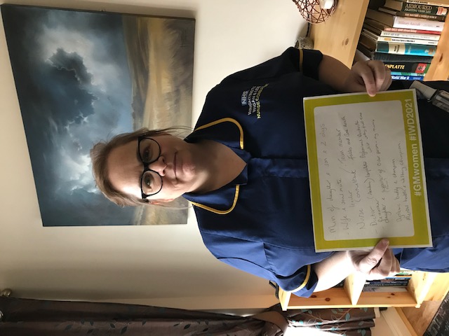 Dr Christina Heaton holding a sign about International Women's Day