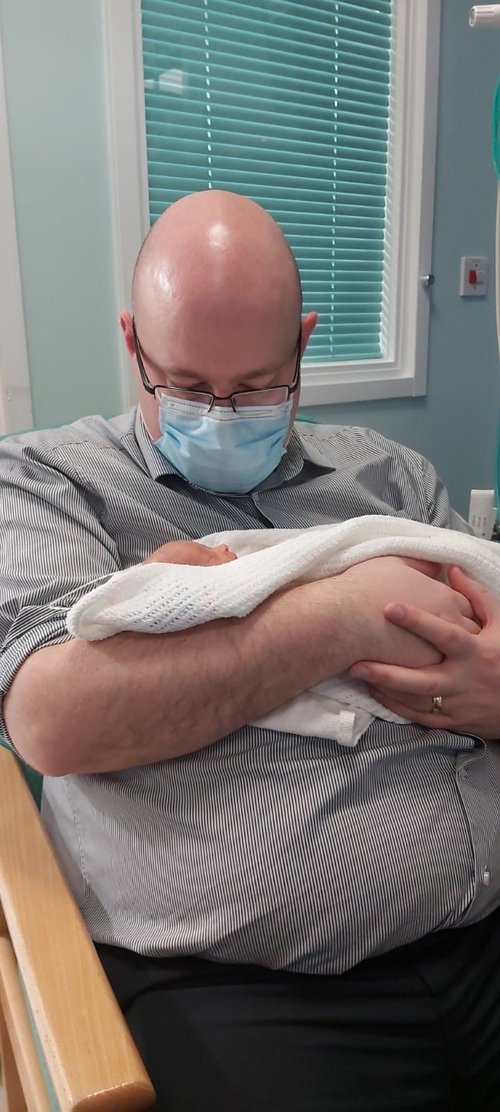 Man holding new born baby