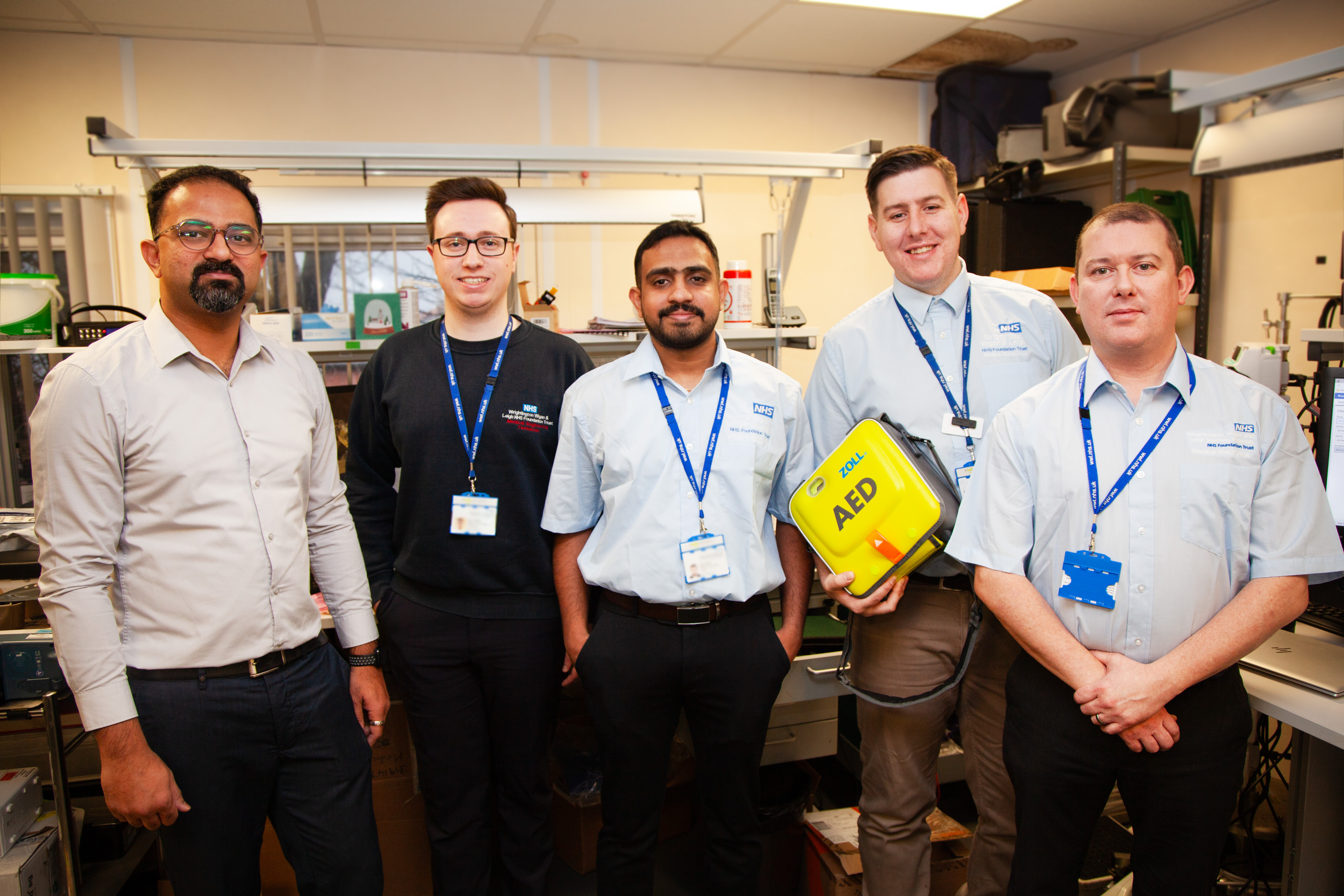 The Medical Electronics Team at WWL, with one member of staff holding a defibrillator