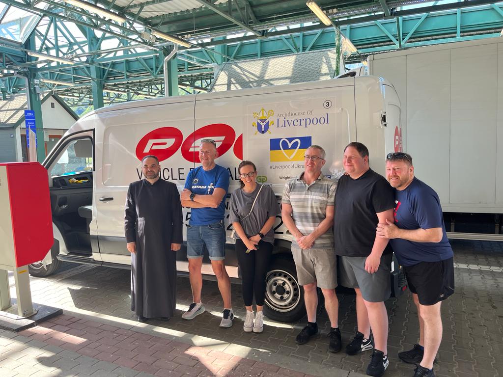 Bishop Gregory Komar (end left) and Mike Sharkey (end right) with volunteer drivers.