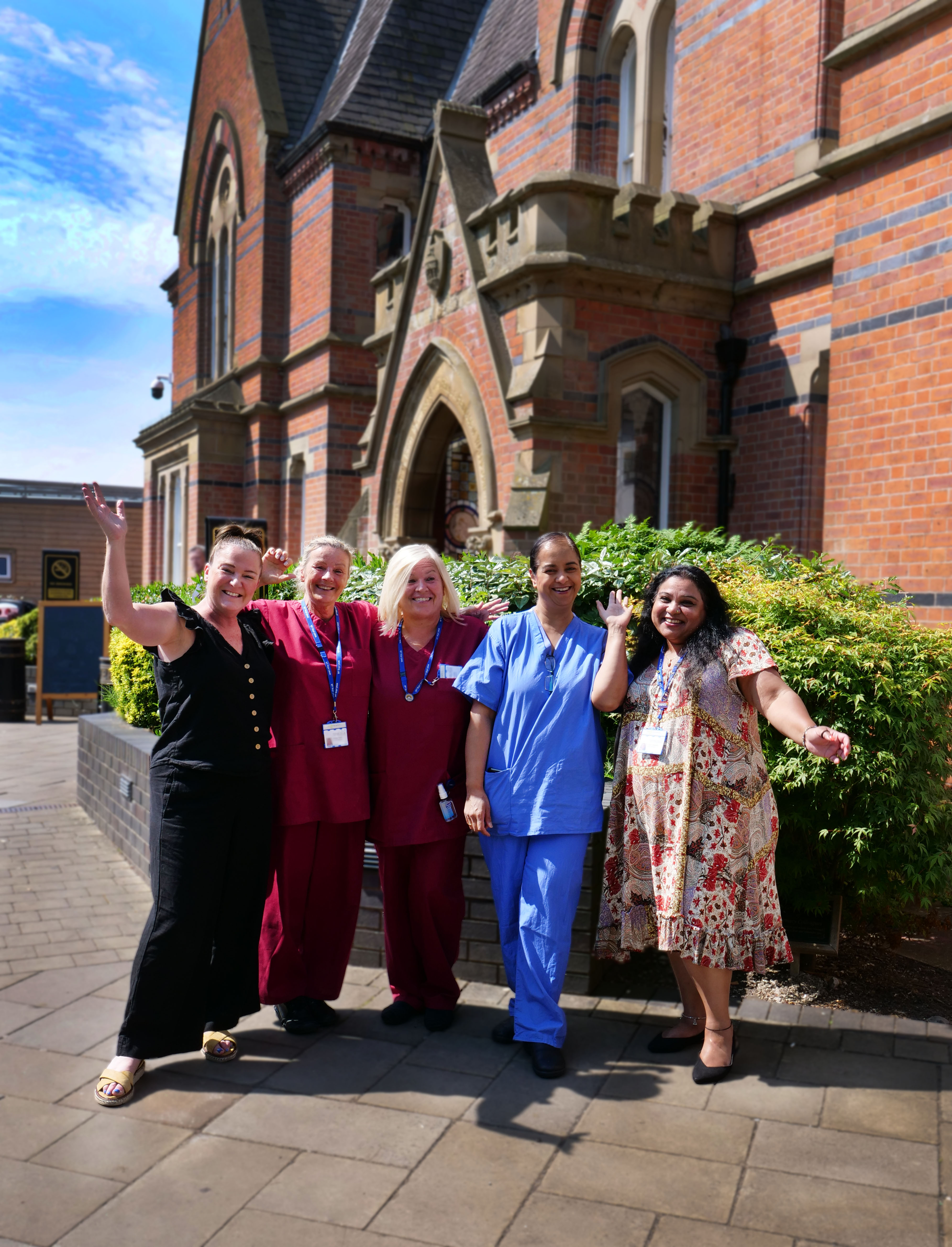 WWL NHS Staff posing for a photograph outside of the Royal Albert Edward Infirmary entrance